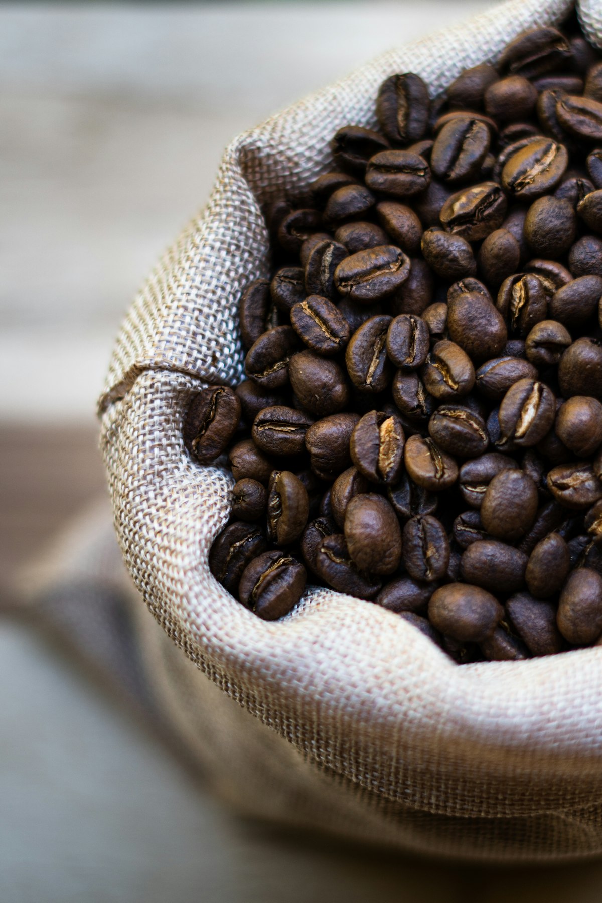 A sack of roasted coffee beans on a table